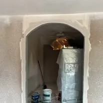Arched alcove masked off and prepared for interior painting