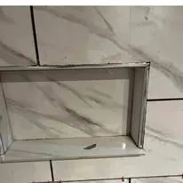 Tiled soffit and bulkhead above a shower surround