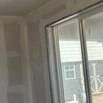 Drywall hung and finished around a new window opening