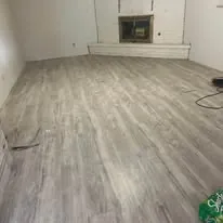 Wide luxury vinyl plank floor laid through an open living area