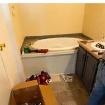 Bathroom mid-remodel with a garden tub and vanity in place