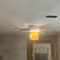 Repaired ceiling drywall around a new light fitting