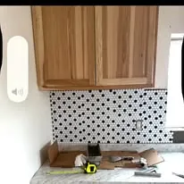 Kitchen wall with a new tile backsplash going in beside the cabinets