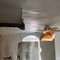 Ceiling and archway drywall under plastic sheeting