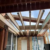 Exposed ceiling beams and interior framing during a remodel