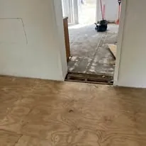 Tile floor meeting bare subfloor at a room transition