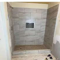 Close view of a tiled shower niche set into the wall