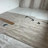 Floor planks and layout tools part way through an installation