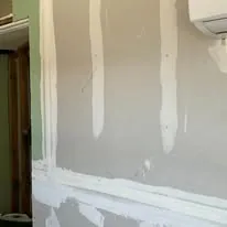 Drywall taped and mudded, joints filled ready for sanding