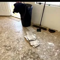 Subfloor exposed during a floor replacement with new planks stacked