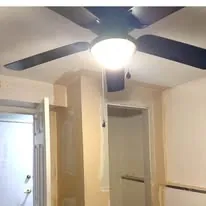 Finished hallway with painted walls, doors and a ceiling fan