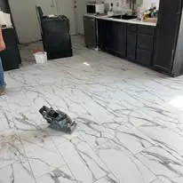Marble-look tile floor laid through a kitchen and dining area in Salt Lake City