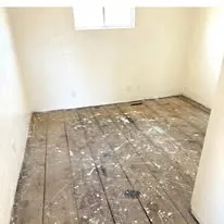 Old flooring stripped back to the subfloor before replacement